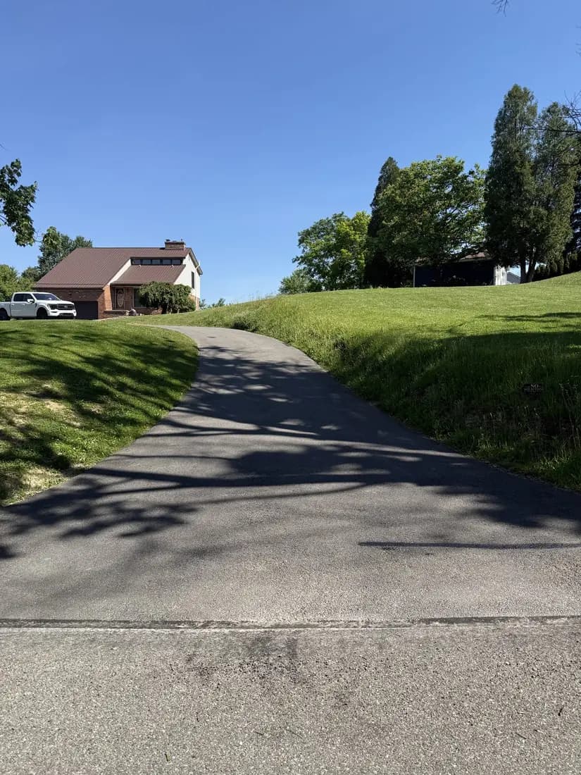 Worn, faded driveway in need of sealcoating
